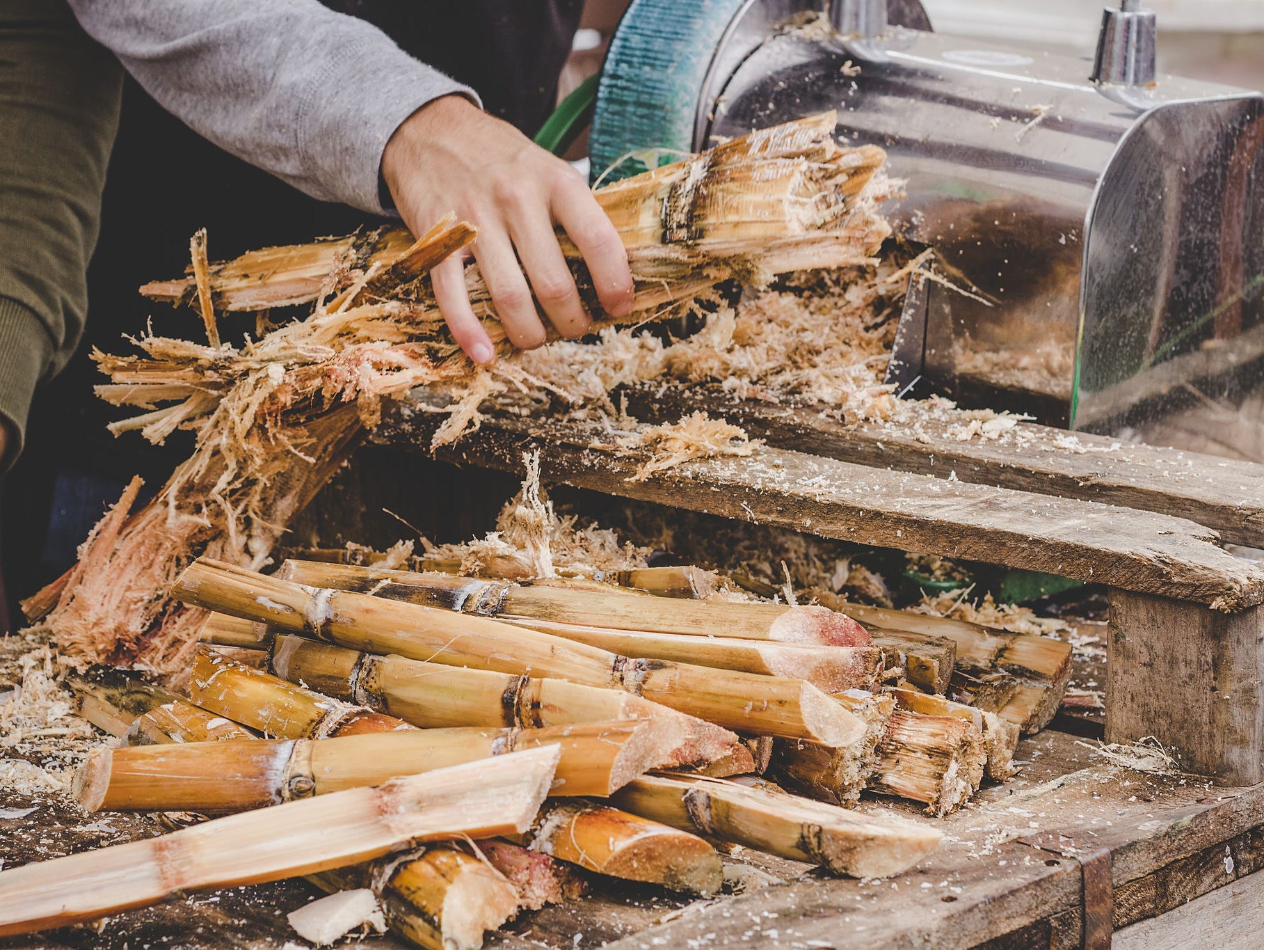 Man queezing sugar cane juice at street food market RO & UF for Boiler Feed Water